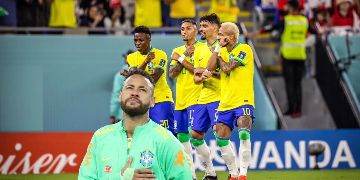 Brazil puts his hand on his chest while the rest of the Brazilian national team dance and celebrate together. (Source: Getty Images)