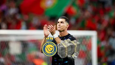 Cristiano Ronaldo claps to the Portugal fans while the Al Nassr badge is next to a stack of cash. (Source: Cristiano Ronaldo X)