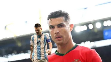 Cristiano Ronaldo looks at the camera with a Portugal jersey on and Lionel Messi looks at the ground with an Argentina jersey. (Source: Messi Xtra X, GOATTWORLD X)