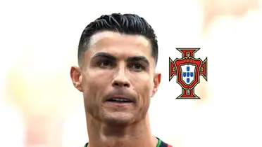 Cristiano Ronaldo looks at the fans while the Portuguese national team badge is next to him. (Source: GOATTWORLD X)