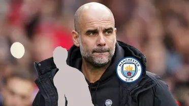 Pep Guardiola wears a jacket while a mystery player is below him but next to the Manchester City badge. (Source: Manchester City)