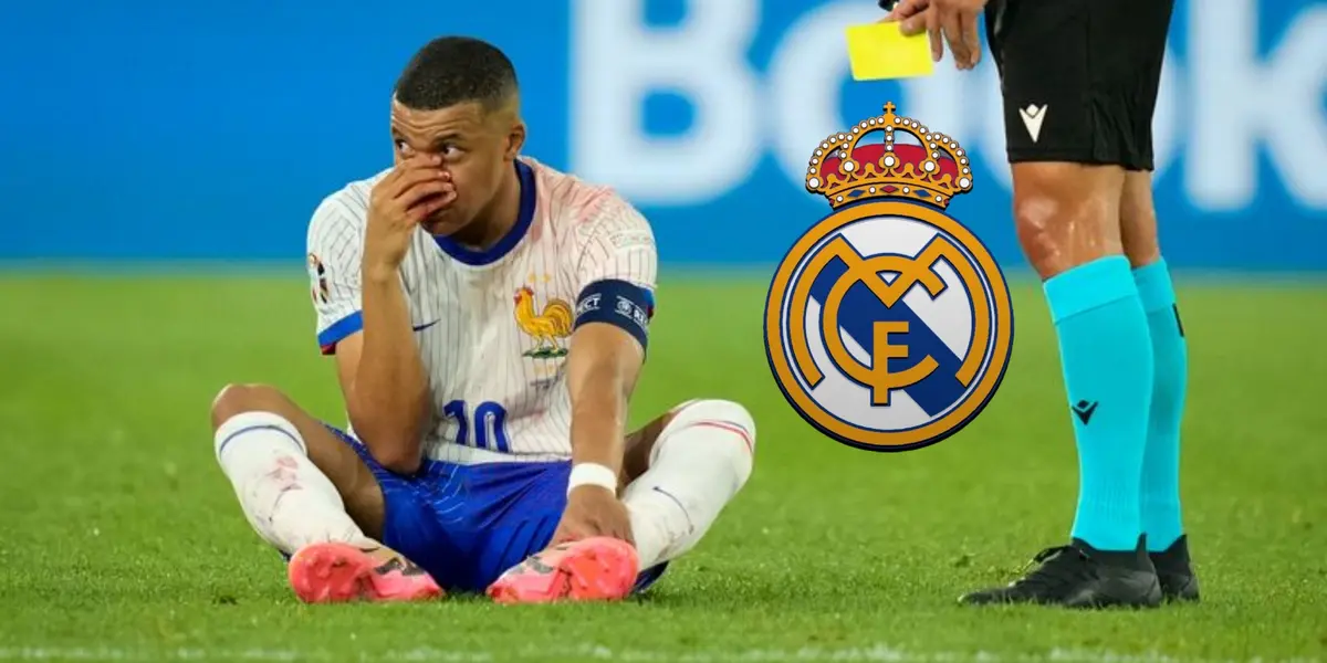 Kylian Mbappé touches his broken nose while on the ground and the Real Madrid badge is next to him. (Source: Sky Sports)